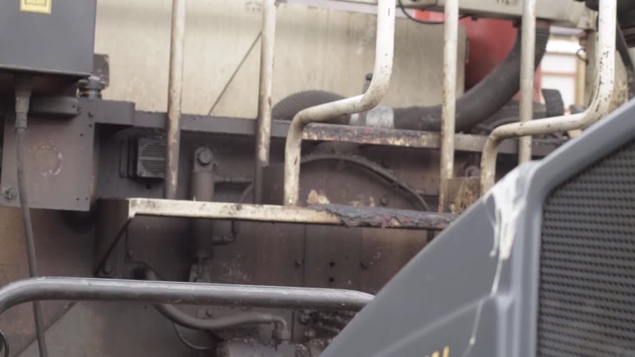 Side view of industrial resurfacing vehicle mechanics close up