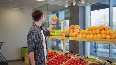 man shopping for fruits and vegetables in a grocery store