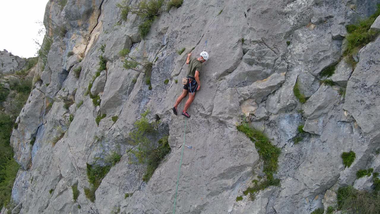 Close going-up drone footage of a man lead climbing in the Pyrenees moutains at Tarascon sur Ari&egrave;ge