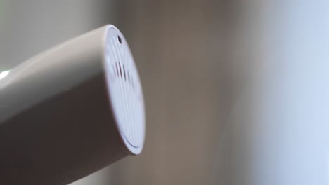 close-up of a steam iron nozzle emitting steam