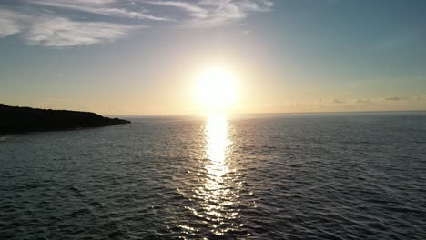glorious sunrise reflections on calm sea waters near sa coma in mallorca, spain. wide aerial