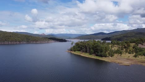 scenic flight over a lake showing green hills in the background