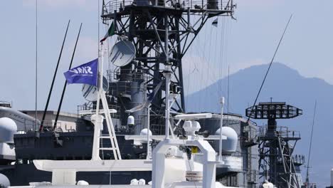 battleship with flag waving in naples, italy