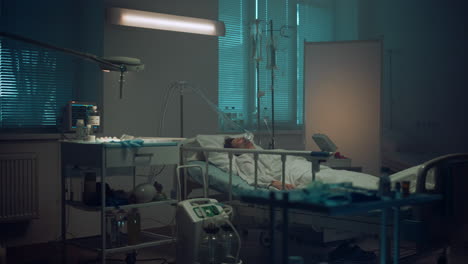 patient lying with oxygen mask in hospital ward. modern operating room interior.