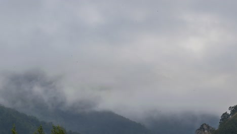 Gray-clouds-floating-over-rocky-mountain-ridge