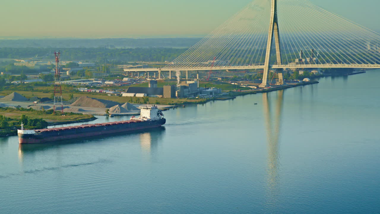 Aerial view capturing a freighter on the Detroit River with the bridge in the background