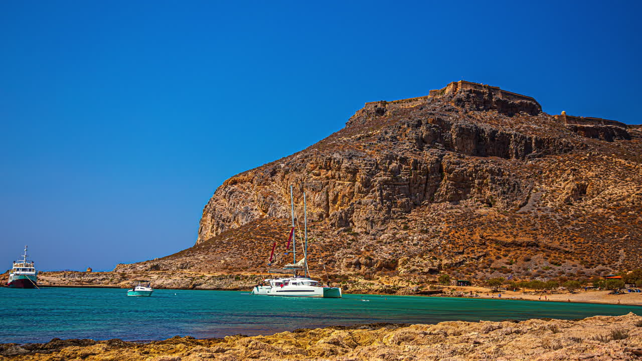 Island of Gramvousa. Beach, boats and Venetian Castle in the top. Crete. Greece. Timelapse video