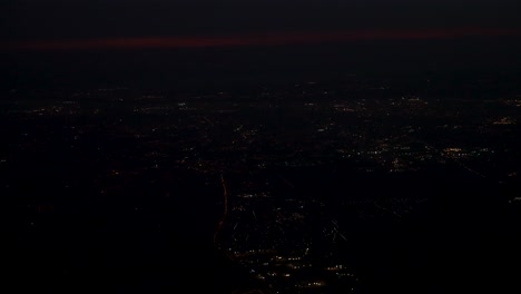 island of tenerife spain at night after airplane takeoff with dusk clouds, left side window view