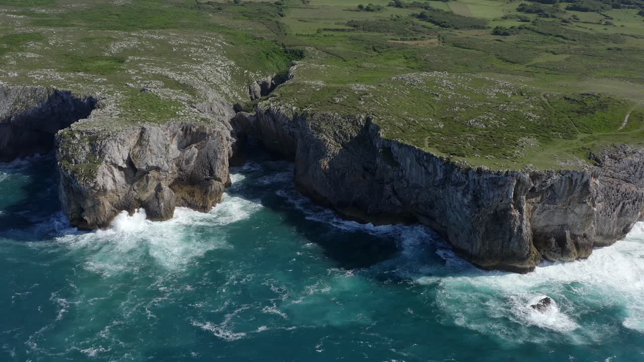 Bufones de pria asturias spain sea cliffs on sunny day, slow motion bird's eye view pullback