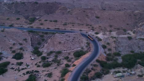 aerial view of mukran national highway as a loaded truck is going down the road, balochistan, pakistan