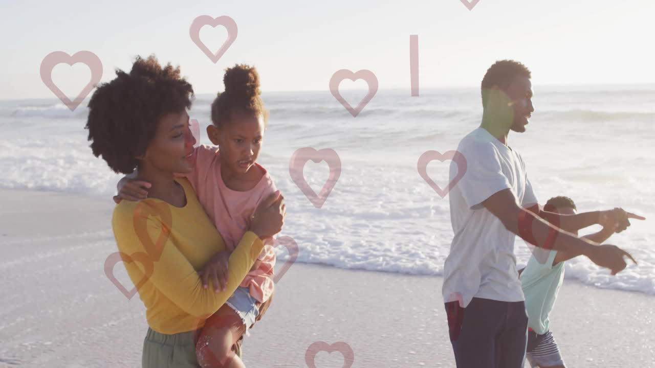 Wandelen op het strand, familie omringd door hartanimaties, genietend van quality time samen.