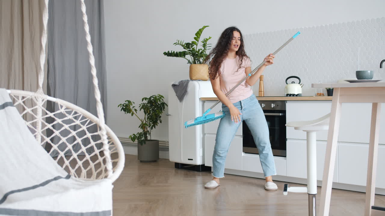 Woman Cleaning and Dancing in Kitchen