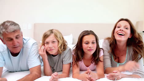 family lying on a bed