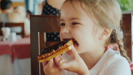 The-Portrait-Of-A-Little-Girl-With-Two-Pigtails-Which-Eats-A-Chocolate-Waffle-All-Smeared-With-Sweet