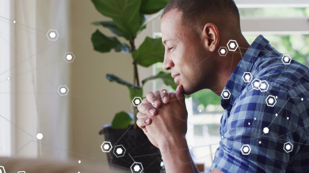 Man hands clasping chin thinking and raising as window light moving hex nodes overlaying for tech