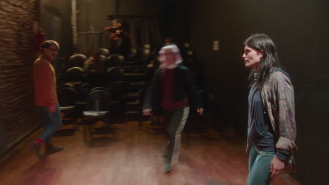 young actors performing on stage of modern theater