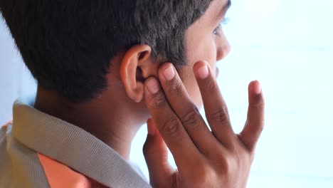 child touching ear