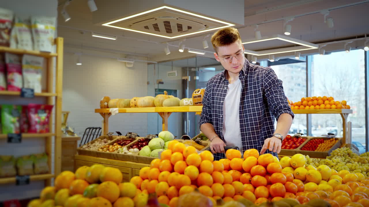 Man Shopping for Oranges in a Grocery Store