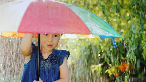 funny girl hiding under an umbrella from the rain warm summer rain slow motion