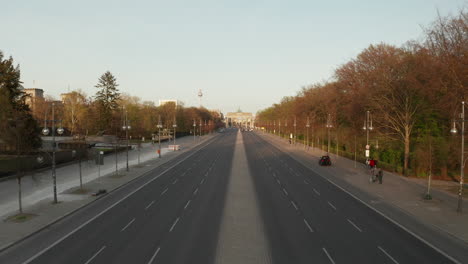 AERIAL:-Empty-Brandenburger-Tor-in-Berlin,-Germany-due-to-Coronavirus-COVID-19-Pandemic-in-Sunset-Light