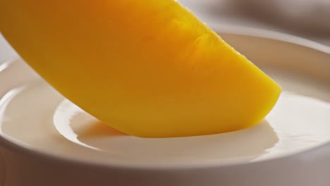 mango slice dipped in creamy yogurt