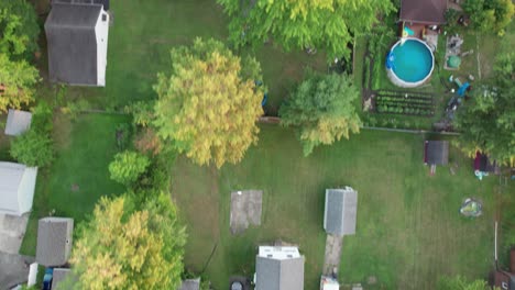 aerial footage shot by a drone from a great height shows the small town's intricately patterned roads and tree cover