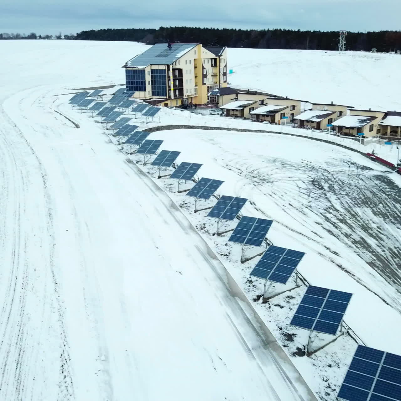 Recreation center with solar panels covered with snow on the outskirts of the city.