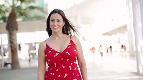 smiling woman in red floral dress outdoors