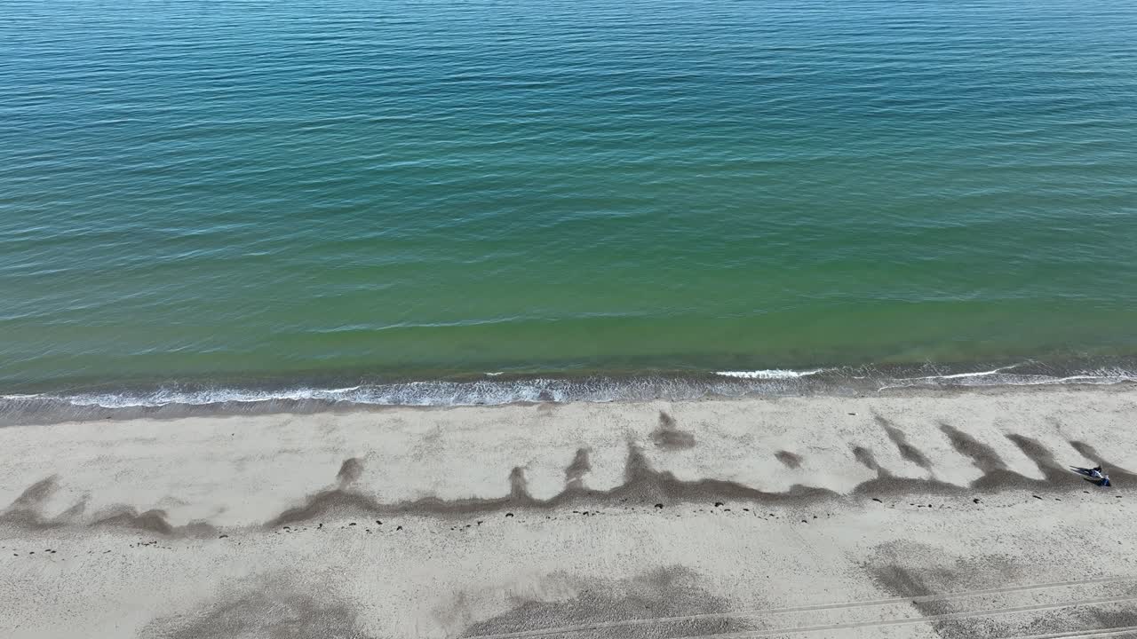 Aerial View of a Person Relaxing on a Secluded Beach