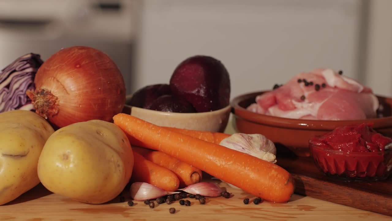 Borscht Ingredients, beetroot soup, Raw fresh vegetables: carrot, cabbage, potatoes, onion, beet, tomatoes pasta and spices and raw chicken. Cooking traditional Ukranian Soviet Union Russian Borsch.