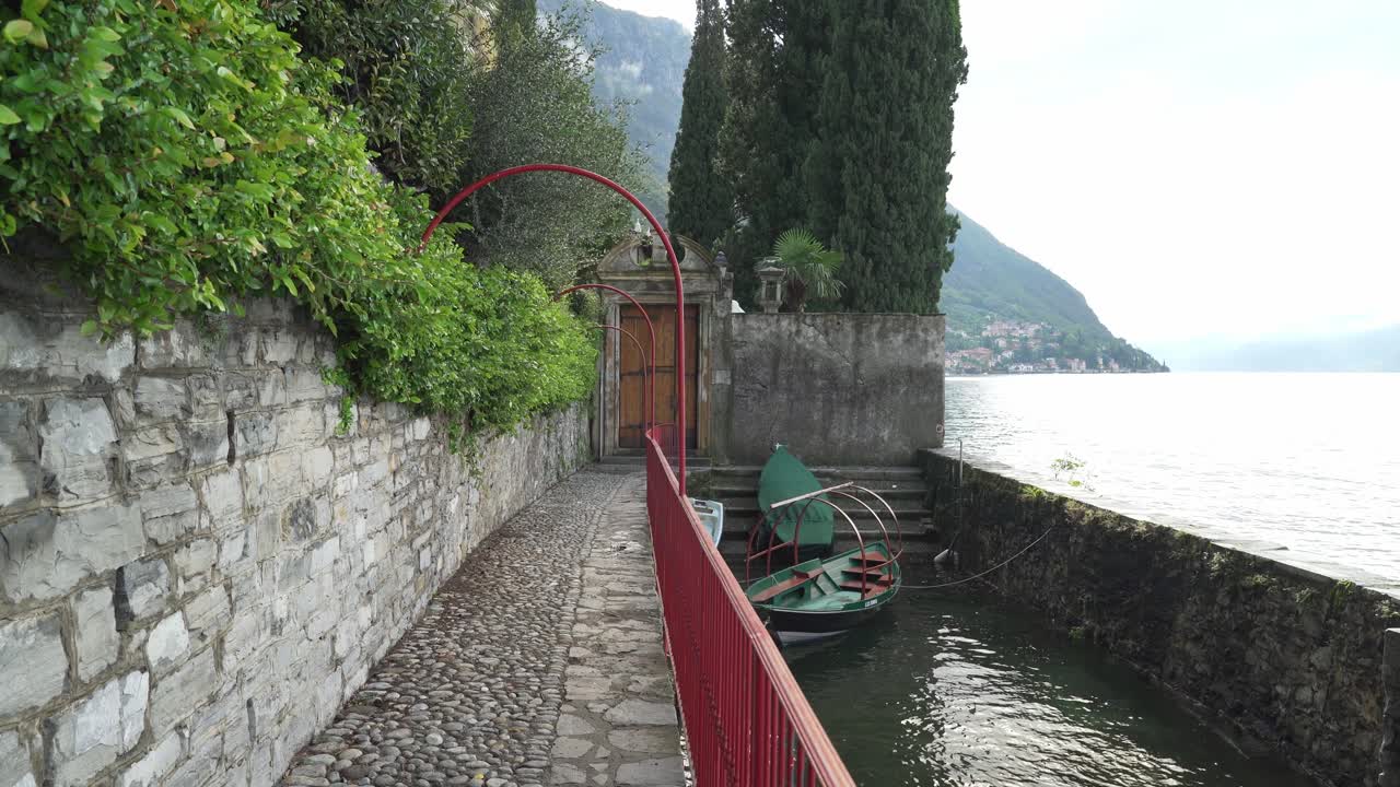 el bote de góndola verde flota cerca de la costa de la ciudad de varenna en el lago como