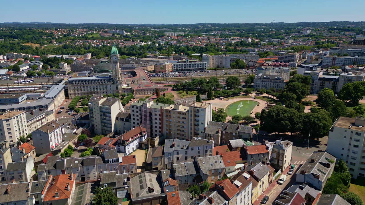 Overview of Champ de Juillet park and train station area in Limoges with blue sky and trees, panoramic aerial