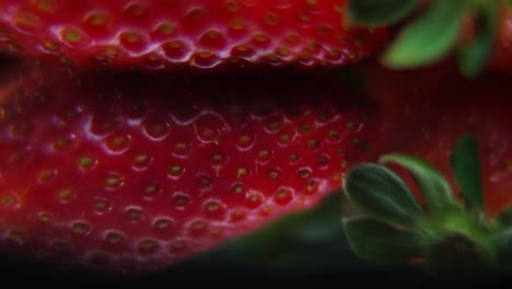 macro detailed video of a pile of strawberries, red strawberry, green leaf, tiny seeds, on a rotating reflection stand, smooth movement, slow motion 120fps