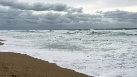 Slow-pan-right-from-the-wet-sand-on-the-beach-to-the-heavy-surf-hitting-the-Mexican-shoreline