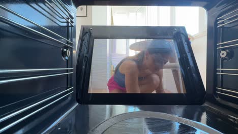 woman cleaning oven