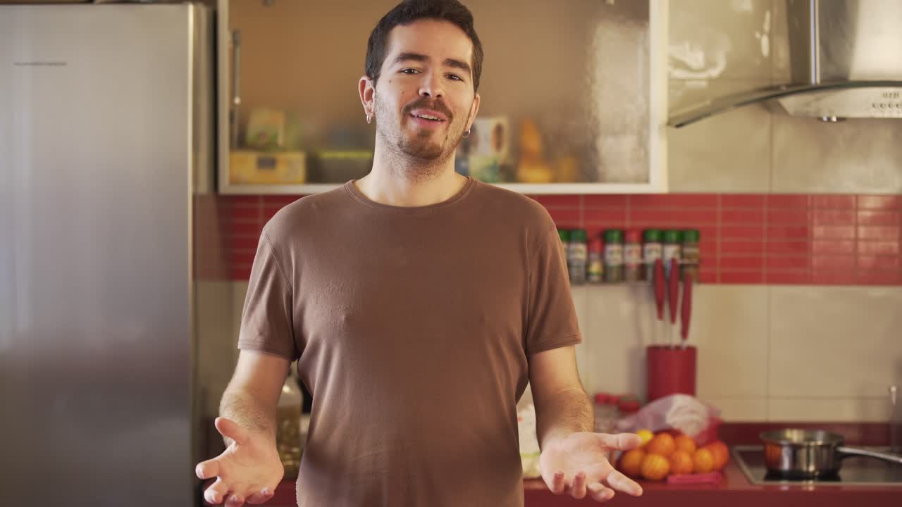 Millennial recording a video of himself in a cuisine talking to his audience