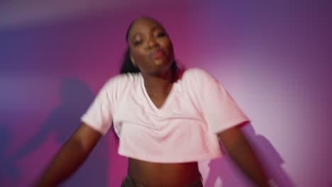 Studio-Shot-Of-Young-Woman-Dancer-Dancing-Against-Blue-And-Pink-Lit-Background-9