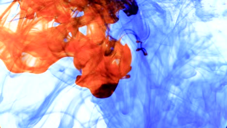 red and blue ink that enters the water forming animated textures, footage ideal for motiongraphic and compositing