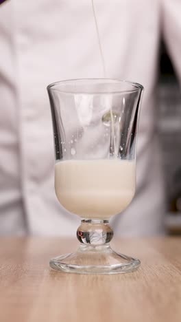 pouring milk into a glass