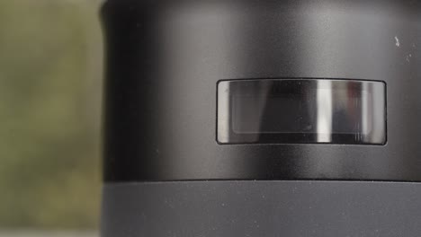 close-up of a black cylindrical device with a rectangular display