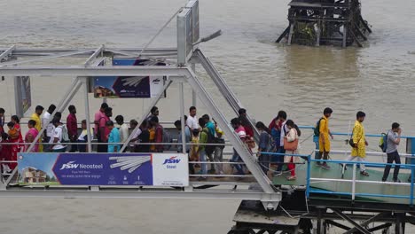 people are boarding the ship from the wharf.