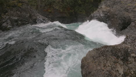 Stunning-overhead-aerial-shot-looking-over-a-powerful-waterfall-on-the-Manso-River-in-Argentina