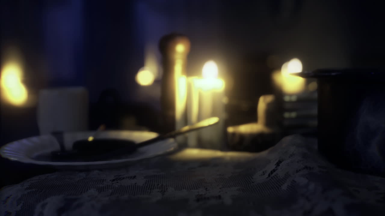 Romantic dinner setting with candles and soft lighting in cozy room