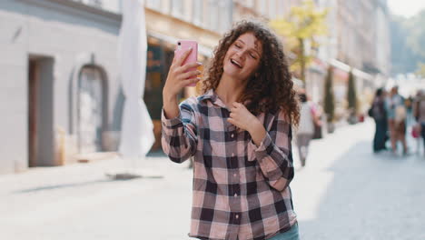 smiling woman takes a selfie on the street