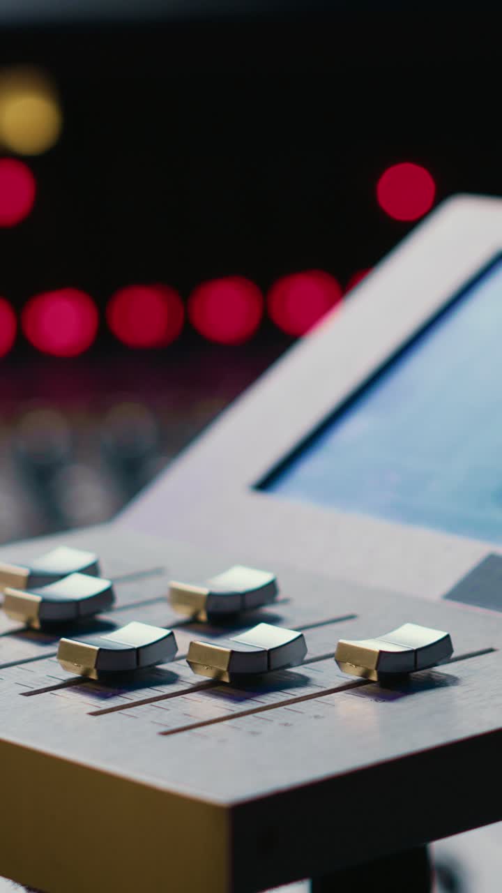Sound Engineer Adjusting Faders on Professional Audio Mixer