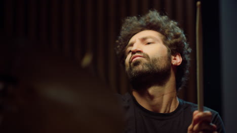 rock musician playing drums in music studio