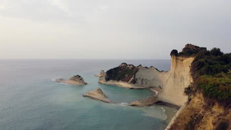 revealing aerial of cape of drastis corfu coast cliff, greece