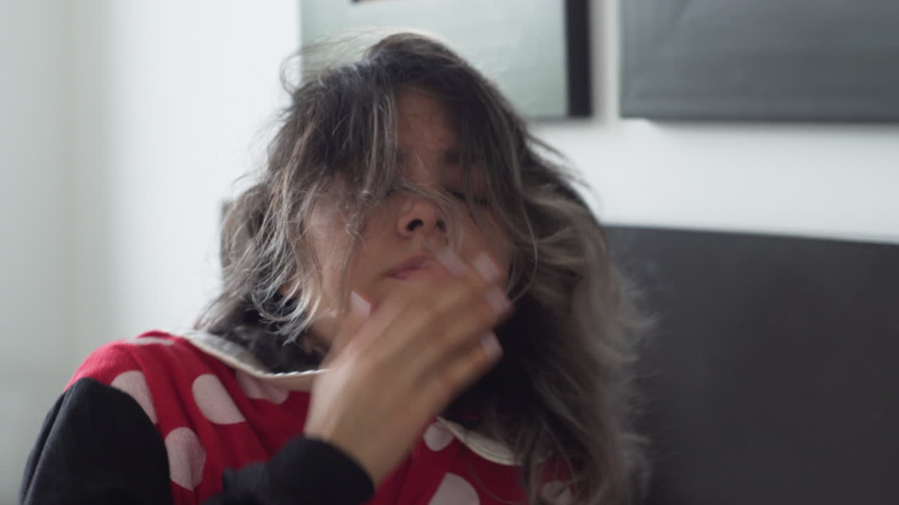 Exhausted woman wakes up in middle of day, close up motion view