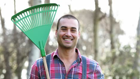 Happy-farmer-holding-rake