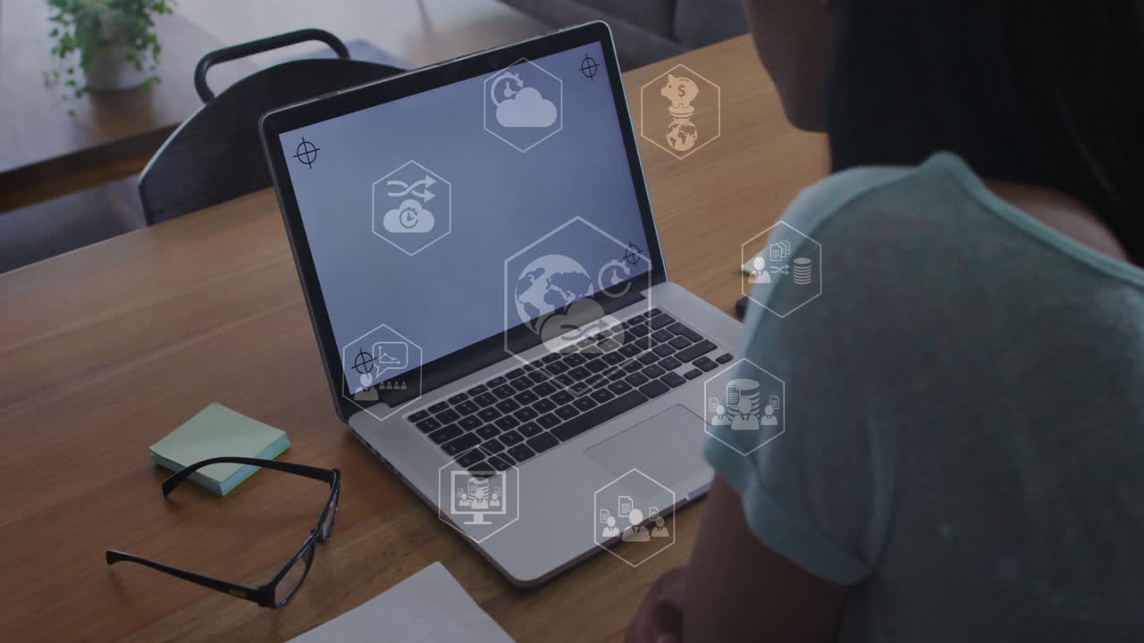 Working on laptop, person with cloud and network animation overlay on screen